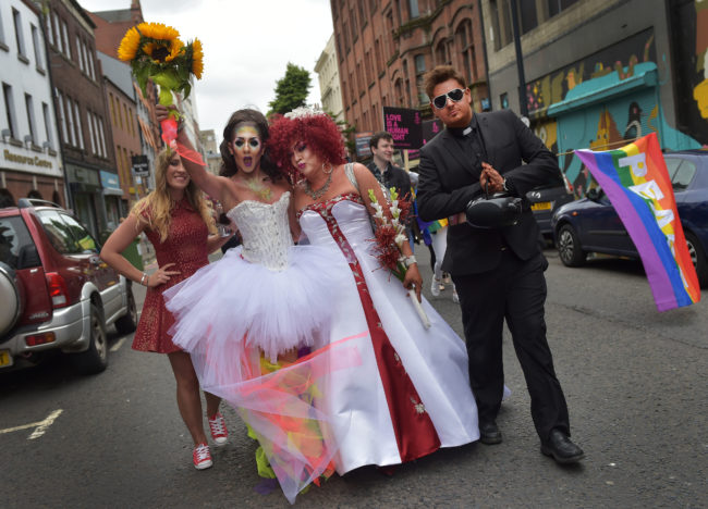 Members of the gay community dressed as brides and a catholic priest make their way along North street as thousands of participants and supporters take part in the 25th annual Belfast Pride parade on August 1, 2015 in Belfast, Northern Ireland. Same-sex marriage whilst legal in the United Kingdom is still not recognised in Northern Ireland despite repeated votes on the issue. The governing Northern Ireland Executive has stated that it does not intend to introduce legislation allowing for same-sex marriage in Northern Ireland.