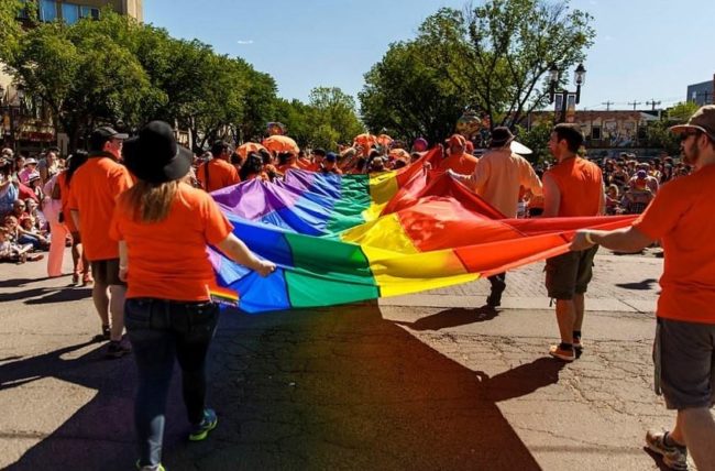 People carrying a rainbow flag at Edmonton Pride