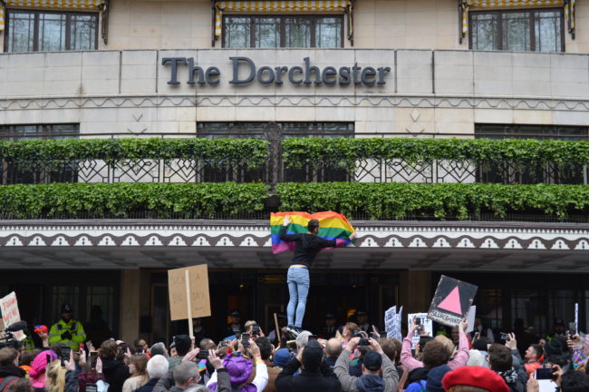 Protest outside The Dorchester hotel in London opposes death penalty for gay sex introduced by Brunei. 