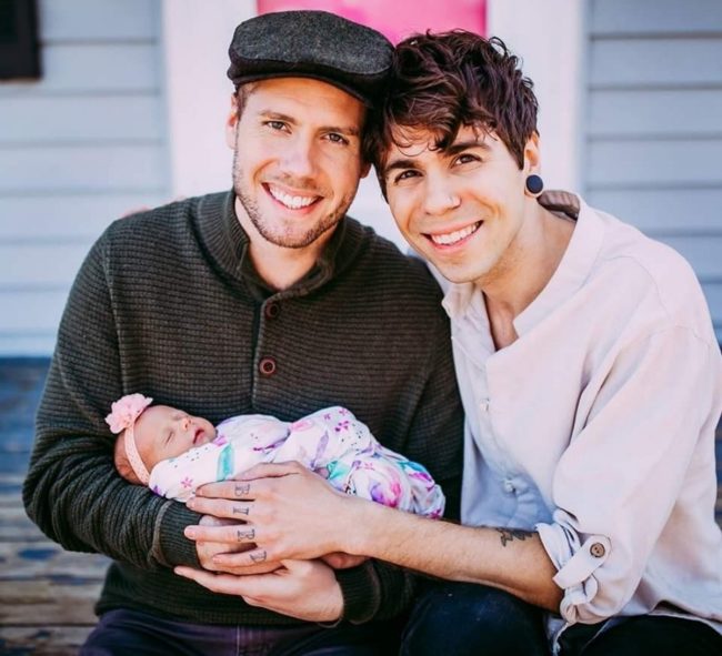 Gay Nebraska couple Elliot Dougherty and Matthew Eledge with their daughter.