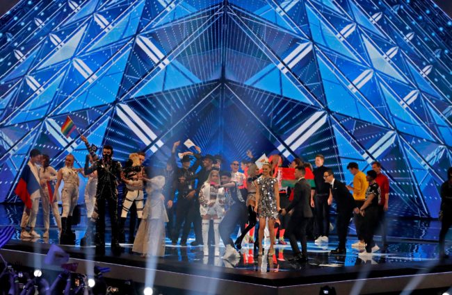 Eurovision finalists pose on the stage, where a member of Hatari waved a LGBT pride flag.